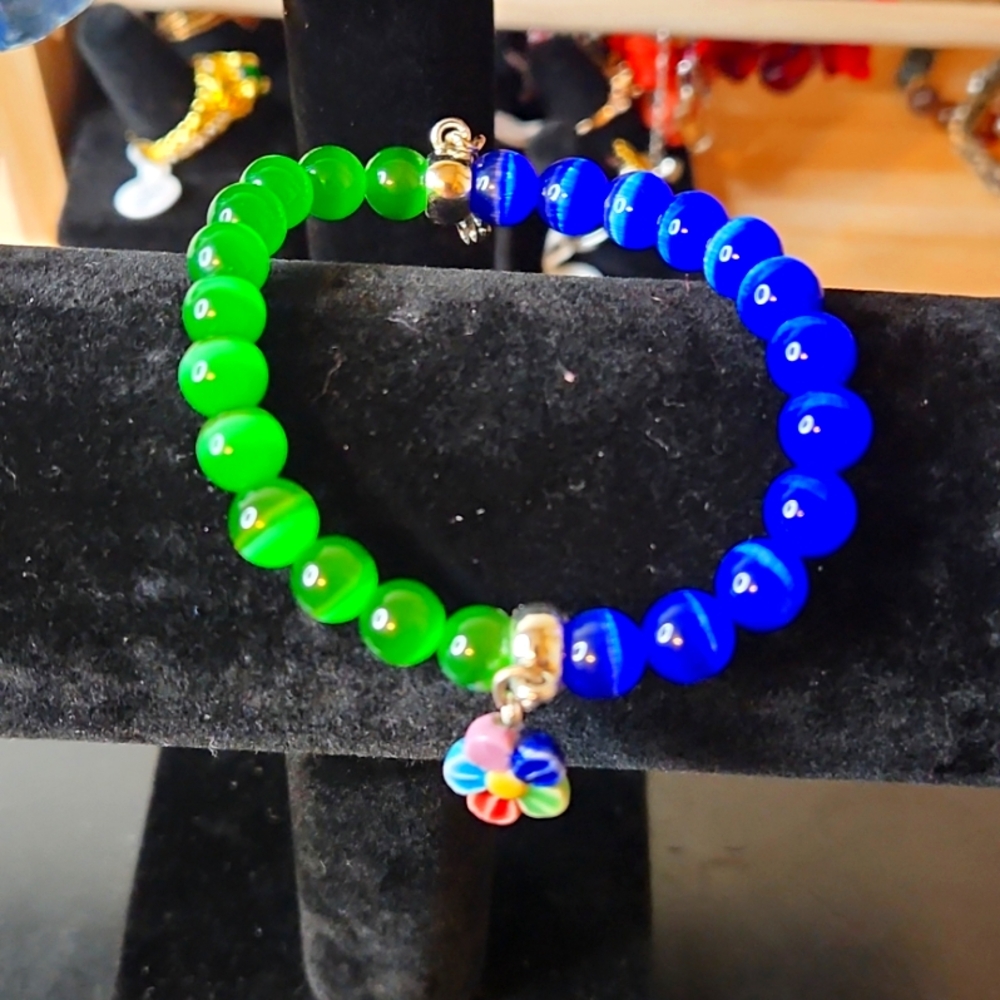 NWT Electric Blue and Green Cat Eye Stretch Bracelet with flower charm.
